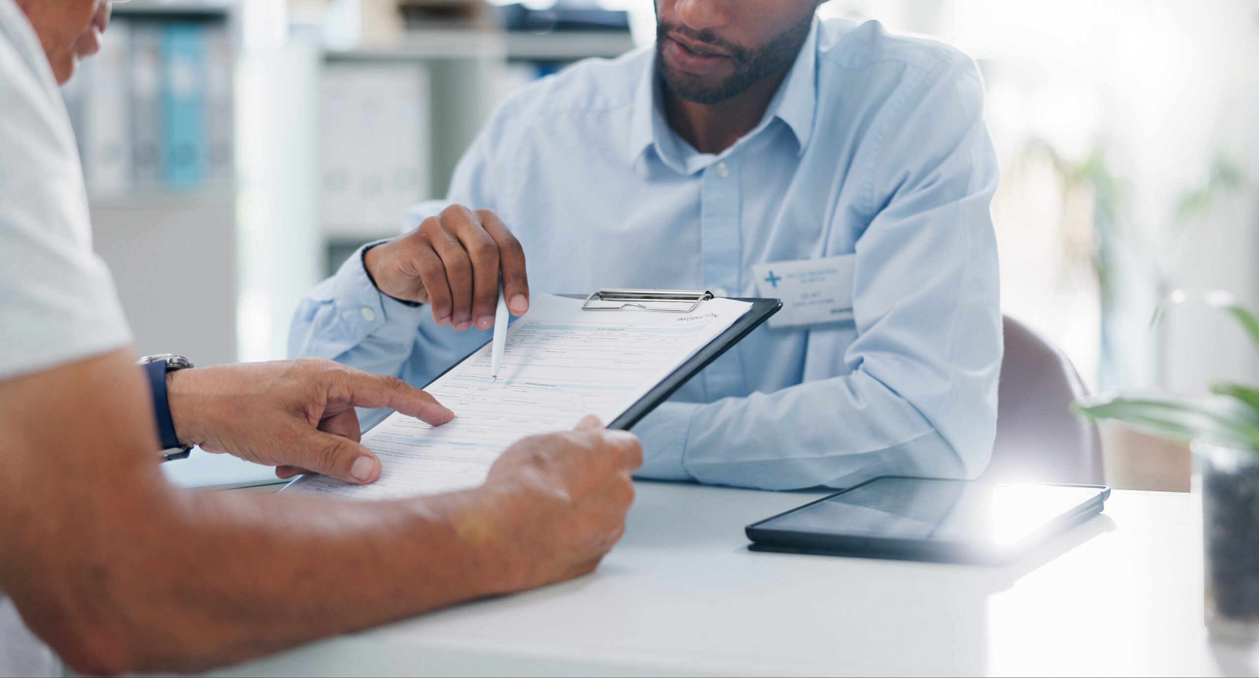 Two people reviewing a form together at a desk